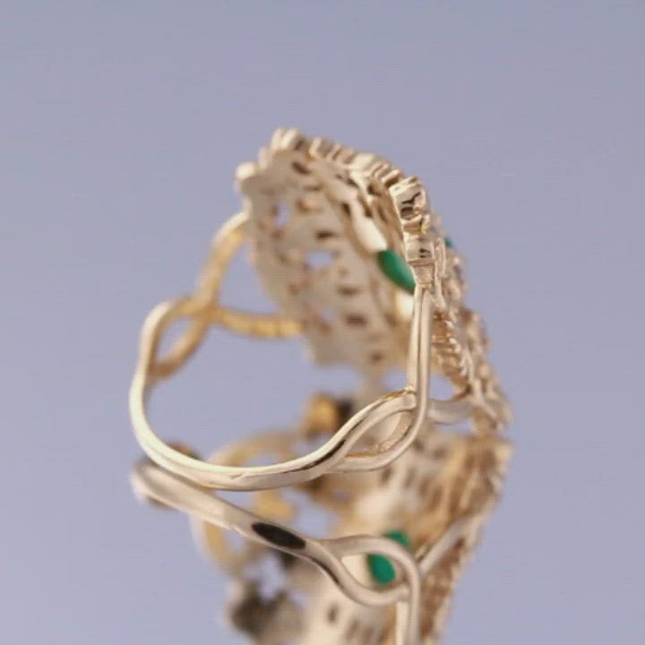 emerald ring with diamonds in a yellow gold